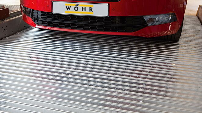 The car is parked on a parking slab